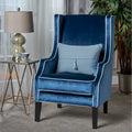 Poltrona decorativa con schienale alto e ali, rivestita in velluto, bordino bianco e gambe in legno nero