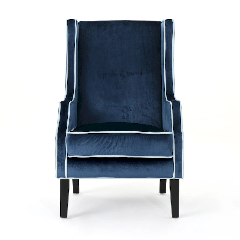 Poltrona decorativa con schienale alto e ali, rivestita in velluto, bordino bianco e gambe in legno nero
