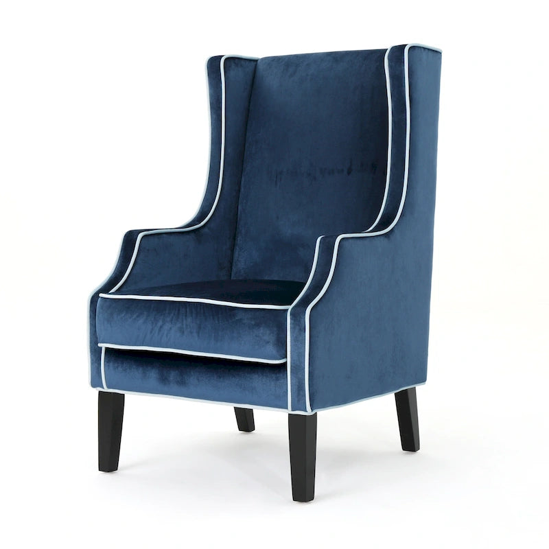Poltrona decorativa con schienale alto e ali, rivestita in velluto, bordino bianco e gambe in legno nero