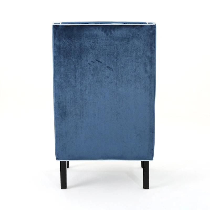 Poltrona decorativa con schienale alto e ali, rivestita in velluto, bordino bianco e gambe in legno nero