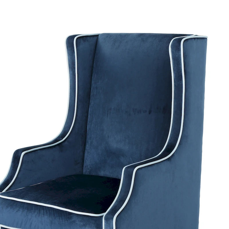 Poltrona decorativa con schienale alto e ali, rivestita in velluto, bordino bianco e gambe in legno nero