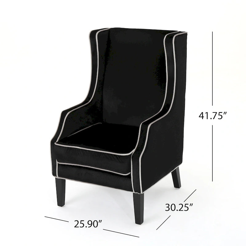 Poltrona decorativa con schienale alto e ali, rivestita in velluto, bordino bianco e gambe in legno nero